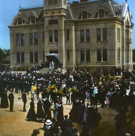 vintage photo of people and a music band gathered outside Old Main